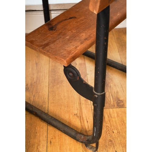 995 - A vintage child's school desk, black painted metal tubular frame with wooden back rest, folding seat... 