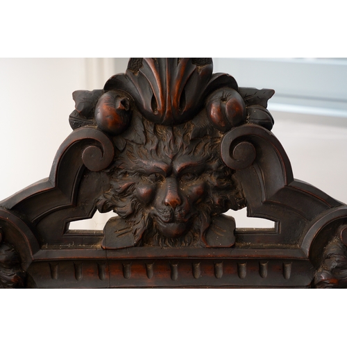 997 - A late 19th century walnut sgabello chair, the back ornately carved with lion masks and central scro... 