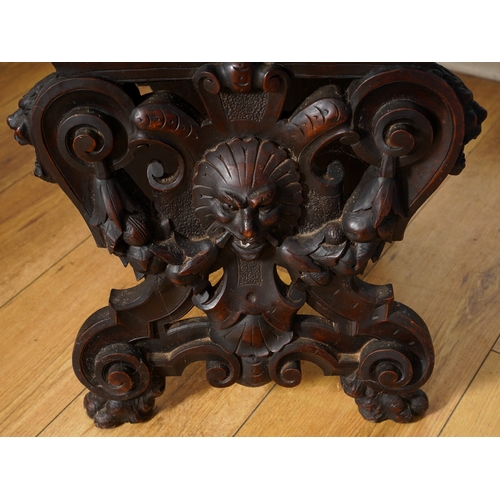 997 - A late 19th century walnut sgabello chair, the back ornately carved with lion masks and central scro... 