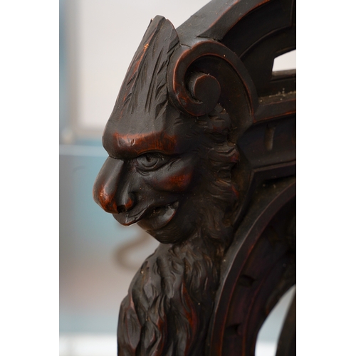 997 - A late 19th century walnut sgabello chair, the back ornately carved with lion masks and central scro... 