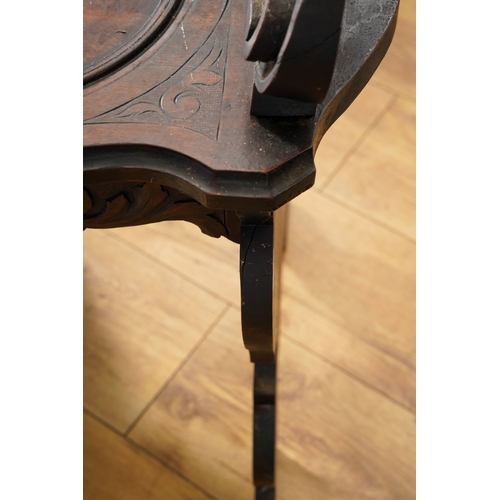 997 - A late 19th century walnut sgabello chair, the back ornately carved with lion masks and central scro... 