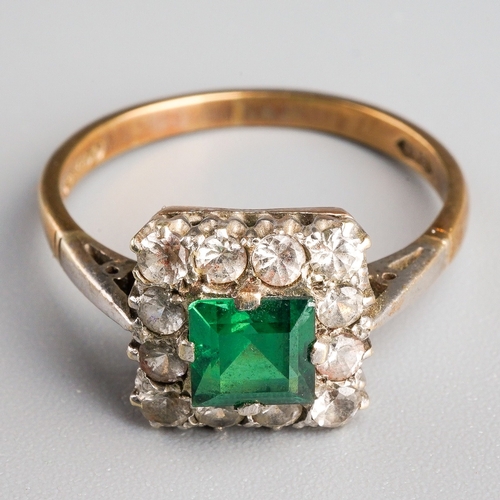 1003 - A 1960s 9ct gold paste cluster ring. Set with a central green paste, surrounded by colourless paste,... 