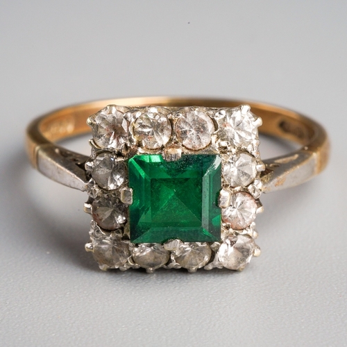 1003 - A 1960s 9ct gold paste cluster ring. Set with a central green paste, surrounded by colourless paste,... 