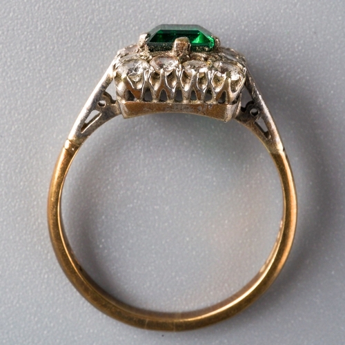 1003 - A 1960s 9ct gold paste cluster ring. Set with a central green paste, surrounded by colourless paste,... 