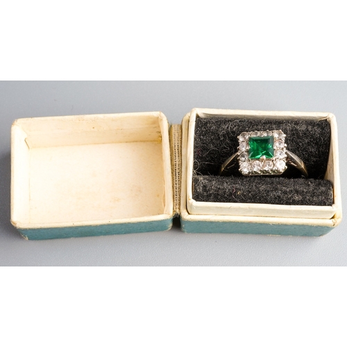 1003 - A 1960s 9ct gold paste cluster ring. Set with a central green paste, surrounded by colourless paste,... 