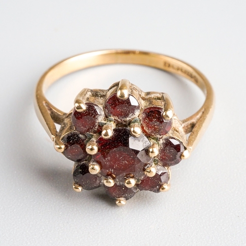 1005 - A 9ct gold garnet cluster ring. Set with garnets, claw set, to the plain polished band, hallmarked 9... 