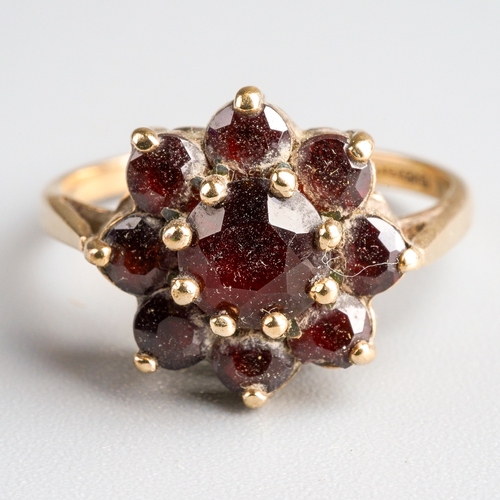 1005 - A 9ct gold garnet cluster ring. Set with garnets, claw set, to the plain polished band, hallmarked 9... 