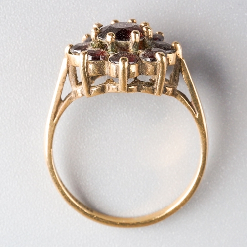 1005 - A 9ct gold garnet cluster ring. Set with garnets, claw set, to the plain polished band, hallmarked 9... 