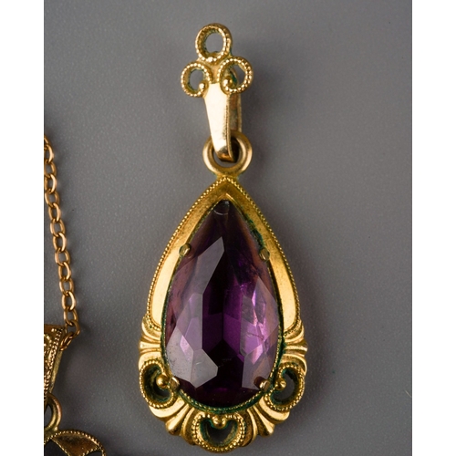 1009 - Two pendants and one chain. One pendant set with a pear shape purple paste, surmount stamped rolled ... 