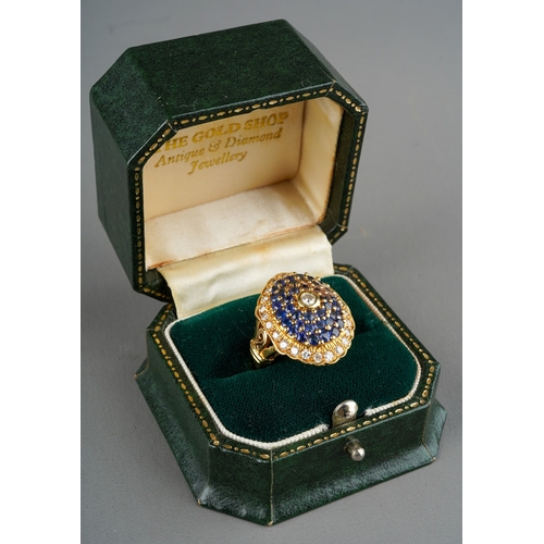 1010 - An 18ct gold diamond and sapphire cluster ring. Set with round brilliant cut diamonds and circular s... 