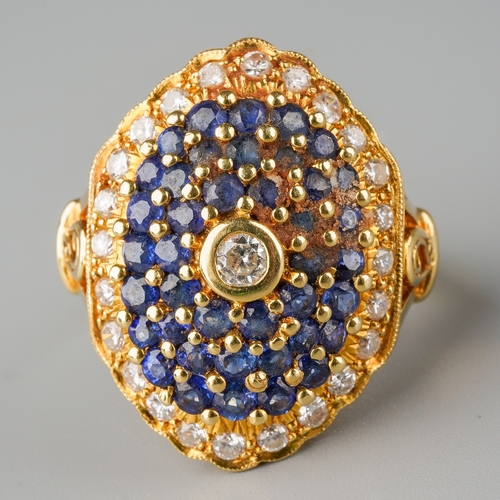 1010 - An 18ct gold diamond and sapphire cluster ring. Set with round brilliant cut diamonds and circular s... 