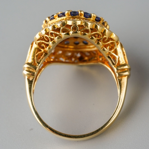 1010 - An 18ct gold diamond and sapphire cluster ring. Set with round brilliant cut diamonds and circular s... 