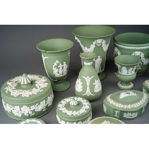 147 - A collection of Wedgwood pale green jasperware, including vases, assorted trinket boxes, pin dishes,... 