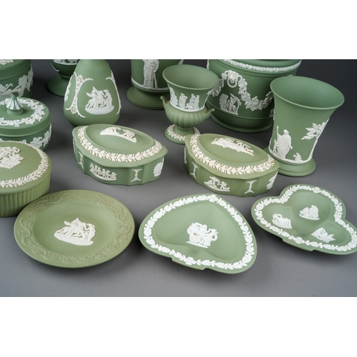 147 - A collection of Wedgwood pale green jasperware, including vases, assorted trinket boxes, pin dishes,... 