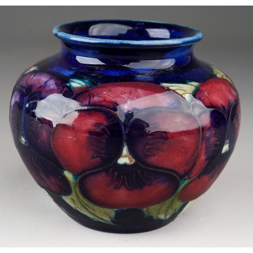 162 - A Moorcroft Pottery squat baluster vase decorated with a Pansy design on a blue ground, impressed ma... 