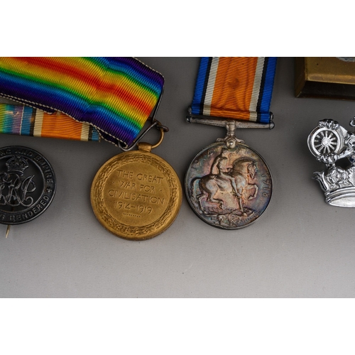 164 - Two WWI medals in original box, awarded to 190131 GNR. J.H.YATES R.A., together with a trench art ma... 