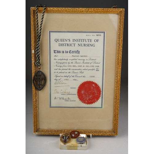 165 - A collection of mid 20th century nursing memorabilia, including a Queens Institute of District Nursi... 