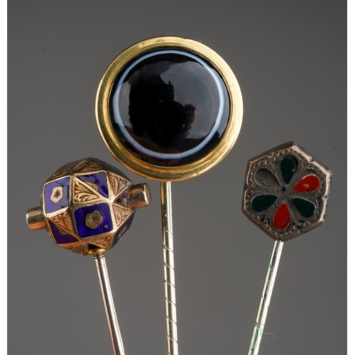 690 - A collection of three late Victorian stickpins, to include a yellow metal blue enamel faceted spheri... 