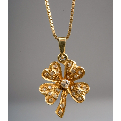 696 - A diamond set four leaf clover pendant with chain, the pendant set with a central round brilliant cu... 