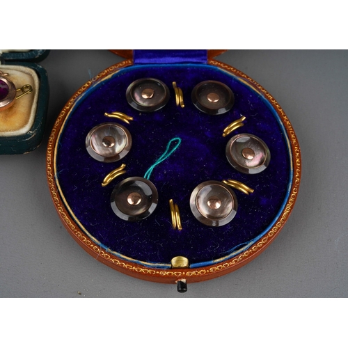 699 - Two sets of cased early 20th century dress studs, the circular case to include a set of six mother o... 