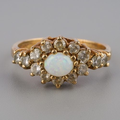 707 - A 9ct gold opal and cubic zirconia dress ring, hallmarked 9ct gold, stamped cz, ring size L, weight ... 