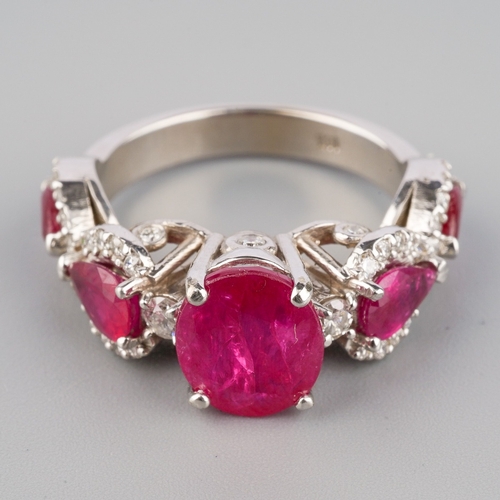 714 - A dress ring, set with glass filled corundum and round brilliant-cut diamonds, estimated total diamo... 