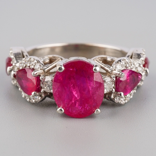 714 - A dress ring, set with glass filled corundum and round brilliant-cut diamonds, estimated total diamo... 