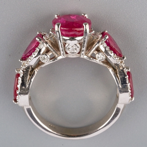 714 - A dress ring, set with glass filled corundum and round brilliant-cut diamonds, estimated total diamo... 