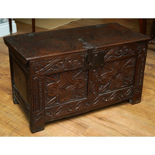 754 - West country Charles I oak coffer, single plank top, two foliate carved panels to the front, panelle... 