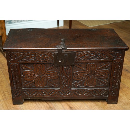 754 - West country Charles I oak coffer, single plank top, two foliate carved panels to the front, panelle... 