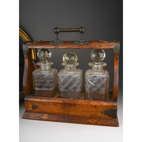 939 - A box of treen etc comprising a late Victorian oak three-bottle tantalus, a circular gilt-framed mir... 