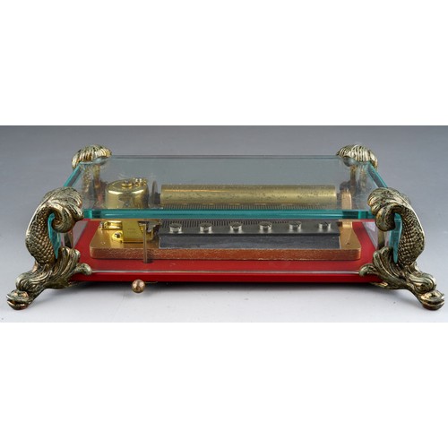 941 - Reuge open works music box with glass panels sat on 4 dolphin feet, with original certificate, worki... 