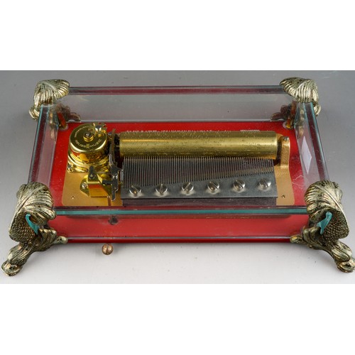 941 - Reuge open works music box with glass panels sat on 4 dolphin feet, with original certificate, worki... 