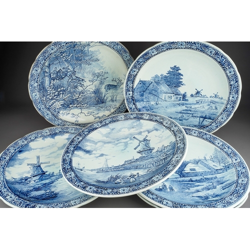 35 - Six large blue and white Delft chargers by Boch with Dutch landscapes, a deer hunt and a couple in a... 