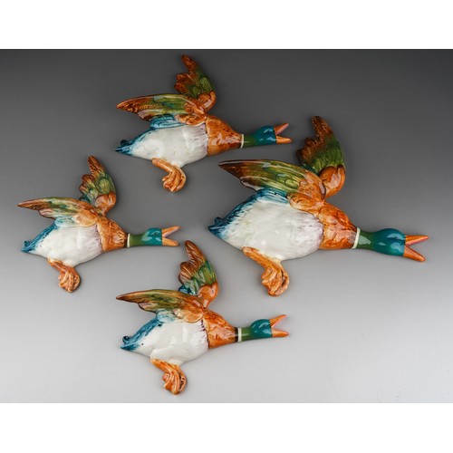 72 - A graduated set of four Beswick graduated flying duck wall plaques, comprising 596-0, 596-1 and two ... 