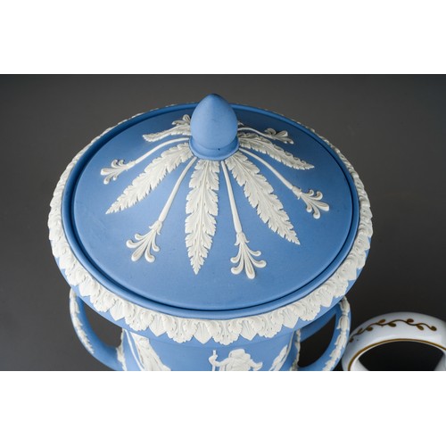 74 - A Wedgwood pale blue jasperware twin handled urn and cover, on a square plinth base, impressed marks... 