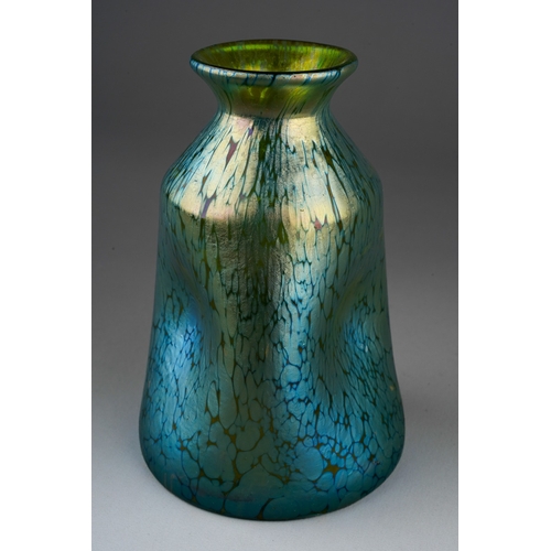 125 - A Loetz style iridescent vase, the flared rim over pinched in body, unmarked, height 11.5cm