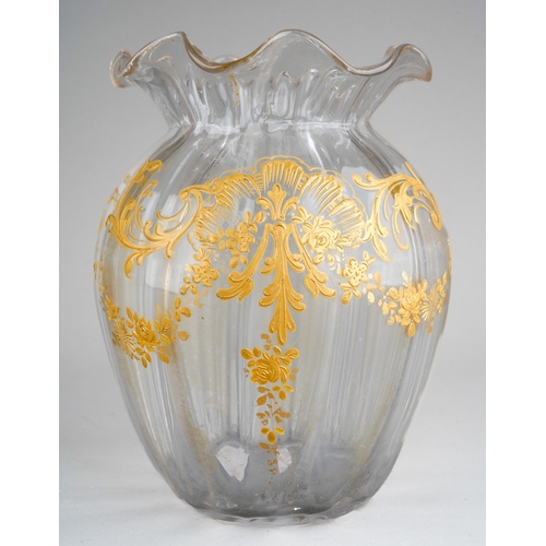 132 - A late 19th clear glass and gilt decorated vase of squat ribbed baluster form, wavy rim, foliate des... 