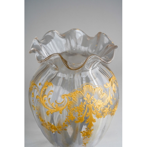 132 - A late 19th clear glass and gilt decorated vase of squat ribbed baluster form, wavy rim, foliate des... 