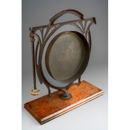 221 - An Art Nouveau style copper and brass table top dinner gong, mounted on a rectangular oak base, with... 