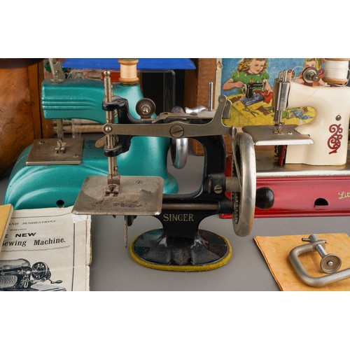 242 - Four vintage Child`s sewing machines including a blue boxed 