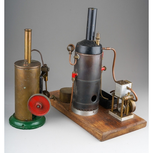 272 - A Burnac Product vertical copper steam engine, powering a flywheel and single cylinder, on a green p... 