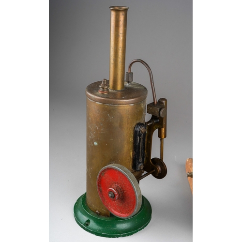 272 - A Burnac Product vertical copper steam engine, powering a flywheel and single cylinder, on a green p... 