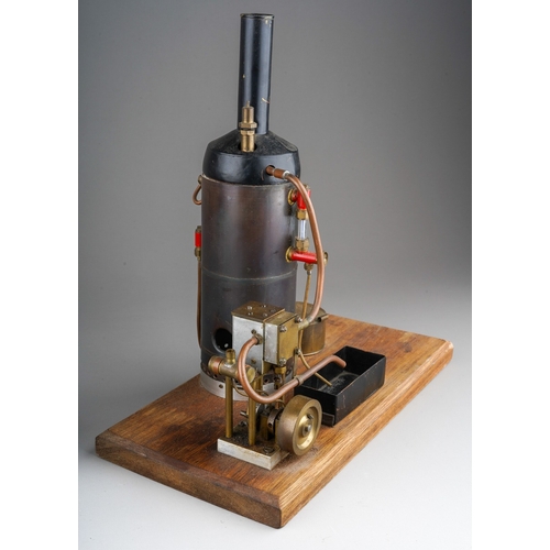 272 - A Burnac Product vertical copper steam engine, powering a flywheel and single cylinder, on a green p... 