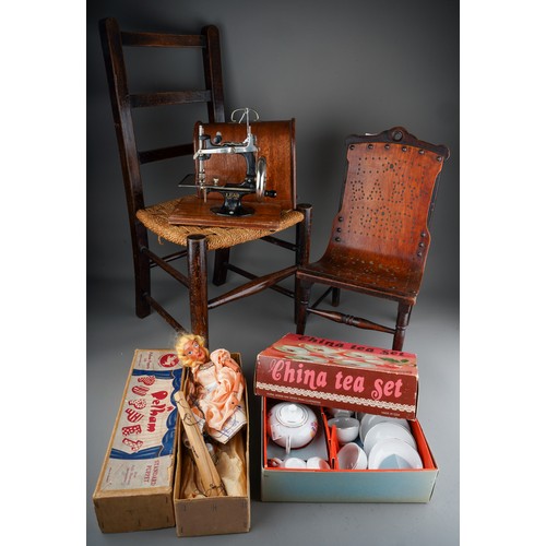 274 - A Lead Child's sewing machine with carrying box, a vintage boxed Pelham puppet (Cinderella) a boxed ... 