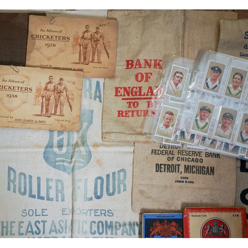 450 - A bag of vintage cloth bank cash and flour bags, a small quantity of cigarette cards in albums and l... 