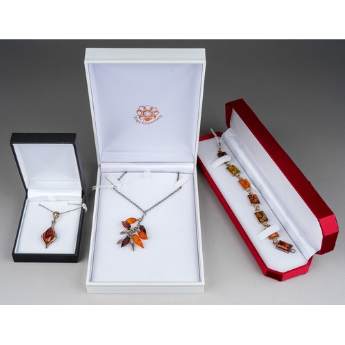 503 - Three items of boxed modern silver and amber jewellery, comprising two necklaces and one bracelet al... 