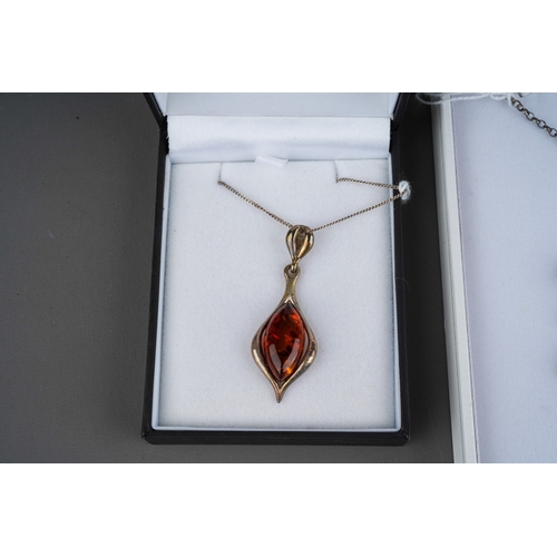 503 - Three items of boxed modern silver and amber jewellery, comprising two necklaces and one bracelet al... 