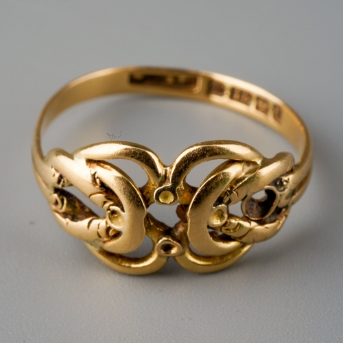 505 - An Edwardian 18ct gold ring, designed as a stylised knot, gemstone settings present but heavily worn... 