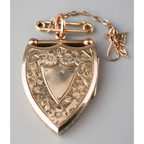 507 - An Edwardian locket, the shield shape locket with foliate embossed detail, approx length of locket 3... 